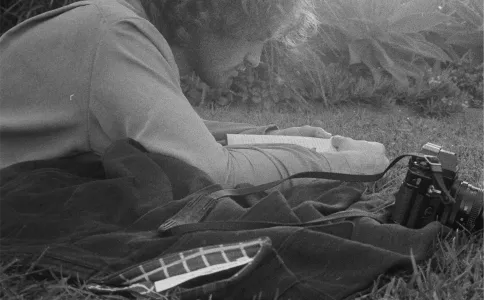 Black and white man lying in grass